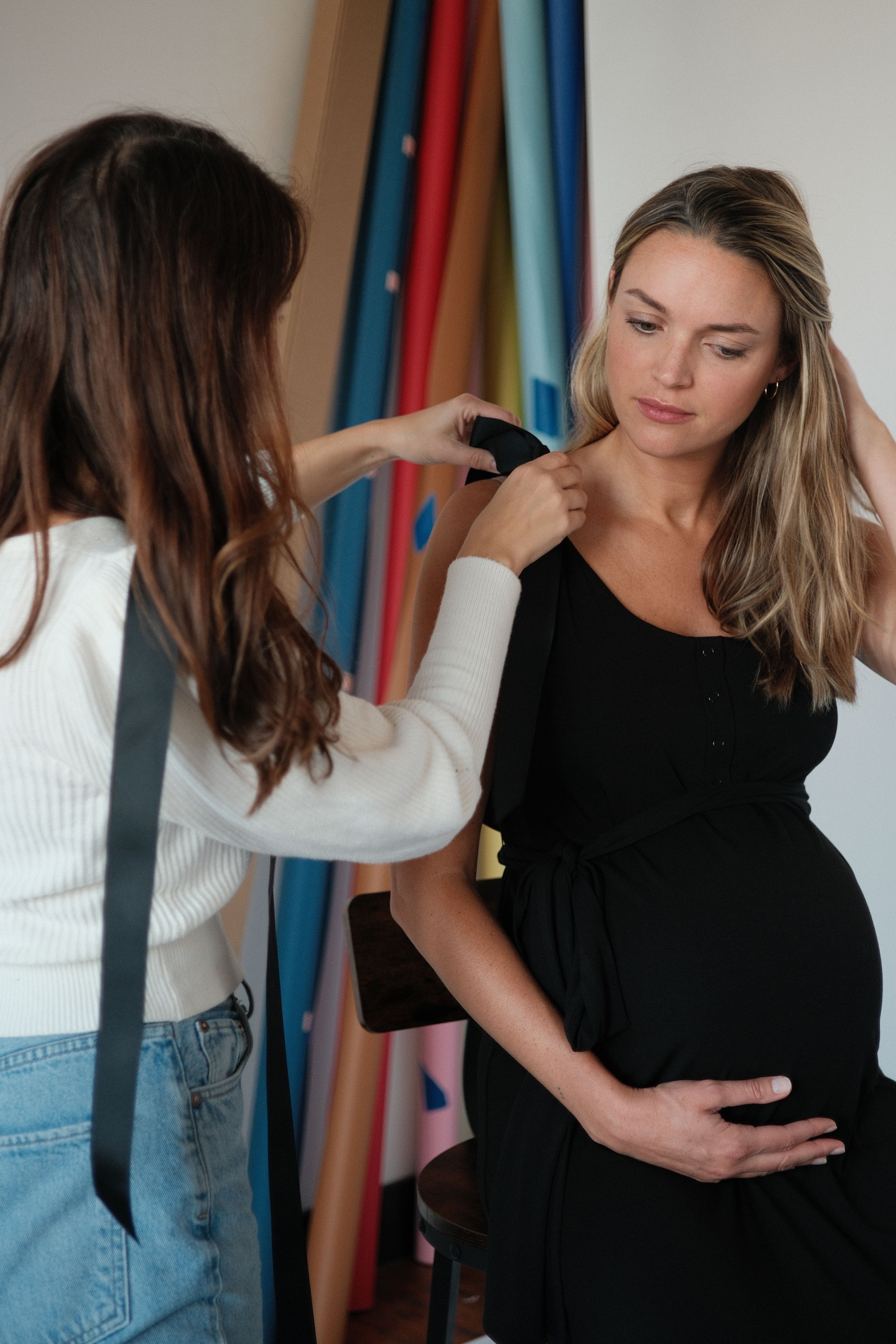 Charlotte maternity dress in black, showing the fluid drape of the heavyweight modal fabric in a studio setting.